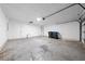 Bright two-car garage with epoxy flooring, white walls, and a garage door leading to the driveway at 8322 Cascade Oaks Dr, Orlando, FL 32822