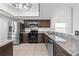 Renovated kitchen boasts granite countertops, stainless steel appliances, and dark cabinetry at 8322 Cascade Oaks Dr, Orlando, FL 32822