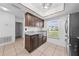 Bright eat-in kitchen with stainless steel refrigerator, granite countertops, and light-colored tile flooring at 8322 Cascade Oaks Dr, Orlando, FL 32822