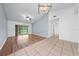 Open living room with wood flooring, a ceiling fan, and access to a patio at 8322 Cascade Oaks Dr, Orlando, FL 32822