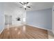 Bright living room features modern wood floors, a ceiling fan, and an open layout with access to the kitchen at 8322 Cascade Oaks Dr, Orlando, FL 32822