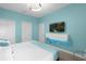 Modern bedroom featuring a mounted TV, storage, and clean, minimalist design at 9020 Stinger Dr, Davenport, FL 33896
