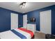 Spacious blue bedroom with closet and dresser at 9020 Stinger Dr, Davenport, FL 33896