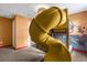 play room with a unique yellow slide, decorative wall paper, and comfortable carpet flooring at 9020 Stinger Dr, Davenport, FL 33896