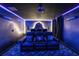 Ambient home theater with leather recliners, accent lighting, and movie-themed décor at 9020 Stinger Dr, Davenport, FL 33896