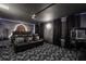 Luxurious home theater with black leather recliners, custom lighting, and a popcorn machine at 9020 Stinger Dr, Davenport, FL 33896