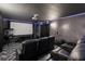 Cozy home theater featuring black leather recliners, ambient lighting, and a vintage popcorn machine at 9020 Stinger Dr, Davenport, FL 33896