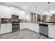 Bright kitchen featuring sleek appliances, white cabinetry, and stylish backsplash at 9020 Stinger Dr, Davenport, FL 33896