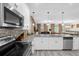 Open kitchen with stainless appliances, granite counters, and view into living space at 9020 Stinger Dr, Davenport, FL 33896