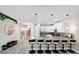 Kitchen with granite countertop island and bar stool seating, flowing into hallway at 9020 Stinger Dr, Davenport, FL 33896
