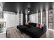 Lovely living room with black sectional sofa, movie-themed decor, and light-colored flooring at 9020 Stinger Dr, Davenport, FL 33896