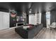 Well-lit living room featuring a black sectional sofa, movie-themed decor, and a ceiling fan at 9020 Stinger Dr, Davenport, FL 33896