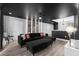 Cozy living room with black sectional sofa, movie-themed decor, and stylish lighting at 9020 Stinger Dr, Davenport, FL 33896