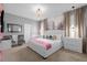 Charming main bedroom with a white bed frame, elegant chandelier and unique Paris-themed wall art at 9020 Stinger Dr, Davenport, FL 33896