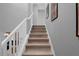 Stairway with wooden steps and white railing at 9020 Stinger Dr, Davenport, FL 33896