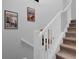 Stairway with wooden steps and white railing, featuring Daily Bugle posters at 9020 Stinger Dr, Davenport, FL 33896