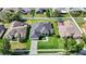 An aerial view of a single-Gathering home with lush green lawn, surrounded by well-maintained properties at 952 Chamberlin Trl, St Cloud, FL 34772