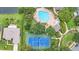 Community aerial view featuring a pool and tennis court, set within a lush, green landscape at 952 Chamberlin Trl, St Cloud, FL 34772