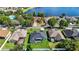 An aerial view shows a well-maintained home and lawn with a serene lake in the distance at 952 Chamberlin Trl, St Cloud, FL 34772