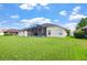 A large screened-in lanai graces the back of this home surrounded by a lush green lawn at 952 Chamberlin Trl, St Cloud, FL 34772