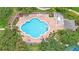 Aerial view of a community pool area with lounge chairs and palm trees for relaxation at 952 Chamberlin Trl, St Cloud, FL 34772