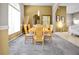 Dining room with wooden table and chairs, large windows, and neutral color scheme at 952 Chamberlin Trl, St Cloud, FL 34772