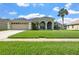 Charming single-Gathering home with manicured lawn, two-car garage, and beautiful arched entryway at 952 Chamberlin Trl, St Cloud, FL 34772