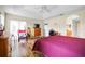 Bright bedroom with hardwood floors, ceiling fan, and sliding glass doors leading to a patio at 952 Chamberlin Trl, St Cloud, FL 34772