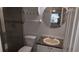 Compact bathroom with a shower, toilet, mirror and a sink vanity provides essential features for a functional space at 9916 Sweepstakes Ln # 7, Orlando, FL 32837