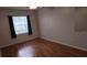 Bright bedroom offers hardwood floors, neutral paint, and a window with shade allowing for natural light at 9916 Sweepstakes Ln # 7, Orlando, FL 32837