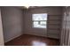 Cozy bedroom with hardwood floors, a built-in bookcase and a window providing natural light at 9916 Sweepstakes Ln # 7, Orlando, FL 32837