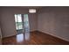 The dining room features hardwood floors, neutral paint, a modern light fixture and sliding glass doors to balcony at 9916 Sweepstakes Ln # 7, Orlando, FL 32837