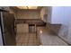 Spacious eat-in kitchen with stainless steel appliances, white cabinetry, tile flooring and granite countertops at 9916 Sweepstakes Ln # 7, Orlando, FL 32837