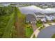 Aerial view of home with lush landscaping, brick driveway, and serene water view at 10364 Shive Island Ct, Orlando, FL 32827