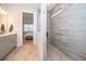 Bright bathroom featuring a glass-enclosed shower and modern vanity with gray cabinets at 10364 Shive Island Ct, Orlando, FL 32827