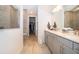 Bright bathroom with double vanity, walk-in shower, and spacious walk-in closet at 10364 Shive Island Ct, Orlando, FL 32827