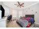 Bright bedroom featuring a ceiling fan, and large windows for natural light at 10364 Shive Island Ct, Orlando, FL 32827