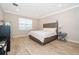 Primary bedroom featuring a plush upholstered bed frame and a large bright window at 10364 Shive Island Ct, Orlando, FL 32827