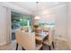 Bright dining room featuring a wooden table with upholstered chairs, and sliding glass doors to the outdoor patio at 10364 Shive Island Ct, Orlando, FL 32827