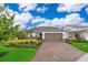 Charming single-Gathering home boasts a well-manicured lawn, lush landscaping, and an attached two-car garage at 10364 Shive Island Ct, Orlando, FL 32827