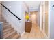 Inviting hallway with wood-look tile flooring, leading to a bright white door and a glass-door bathroom at 10364 Shive Island Ct, Orlando, FL 32827