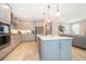 Modern kitchen featuring gray cabinets, stainless steel appliances, a large island, and stylish pendant lighting at 10364 Shive Island Ct, Orlando, FL 32827