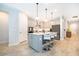 Modern kitchen with stainless steel appliances, an island with seating, and pendant lighting at 10364 Shive Island Ct, Orlando, FL 32827