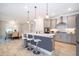 Island kitchen with stainless steel appliances, pendant lighting and breakfast bar seating at 10364 Shive Island Ct, Orlando, FL 32827
