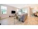 Comfortable living room with neutral tones, a gray couch, and large windows providing natural light at 10364 Shive Island Ct, Orlando, FL 32827