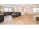 Spacious living room with wood floors, ample natural light, and a modern sectional at 10364 Shive Island Ct, Orlando, FL 32827