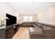Open-concept living room with a large sectional sofa and stylish decor providing a comfortable gathering space at 10364 Shive Island Ct, Orlando, FL 32827