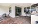 Covered patio area perfect for outdoor entertaining with a built-in grill and spacious brick flooring at 10364 Shive Island Ct, Orlando, FL 32827