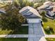 An aerial view of the house showing the roof, lawn, driveway, and surrounding neighborhood at 11730 Kennington Ct, Orlando, FL 32824