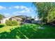 Lush green backyard showcasing the home's screened pool area and manicured lawn at 11730 Kennington Ct, Orlando, FL 32824